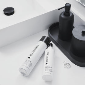 Paul Mitchell being sprayed on styled hair demonstrating long-lasting hold