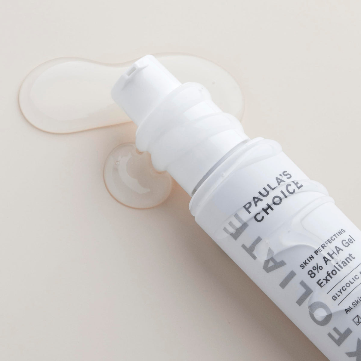 Paula's Choice bottle next to hand to show 3.3 oz scale and travel-ready convenience