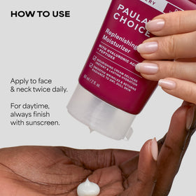 Paula's Choice cream on hand being applied to cheek to show spreadability