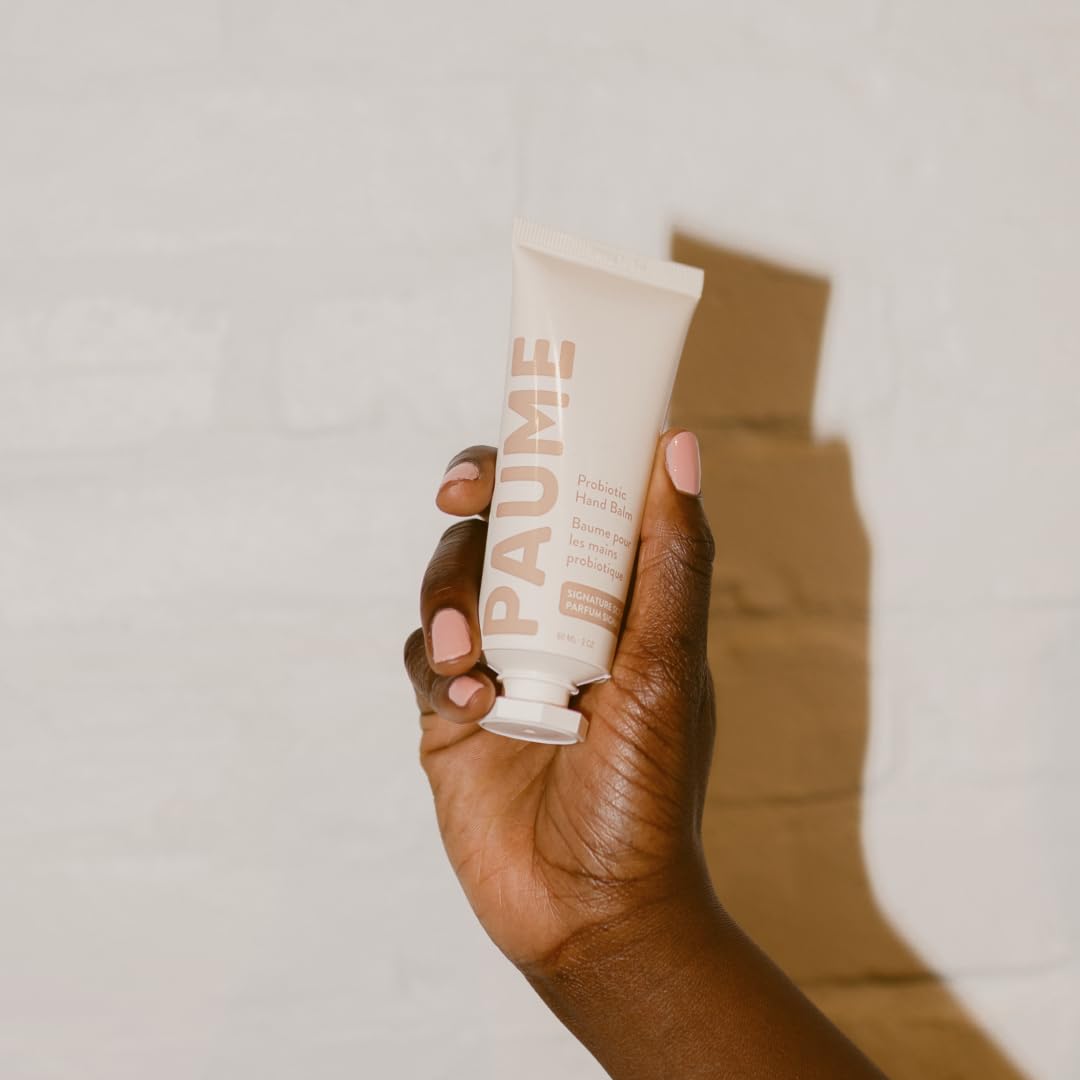 PAUME tube beside a coin for size comparison, useful 2oz travel-friendly option