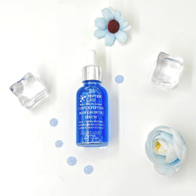 PeptideLabz bottle next to coin to show 1 fl oz size and convenient travel-friendly benefit