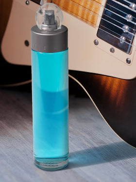 Perry Ellis lifestyle image of travel spray and toiletry bag illustrating on-the-go convenience