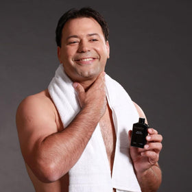 Pherolink Freelette bottle beside razor showing compact size and travel convenience