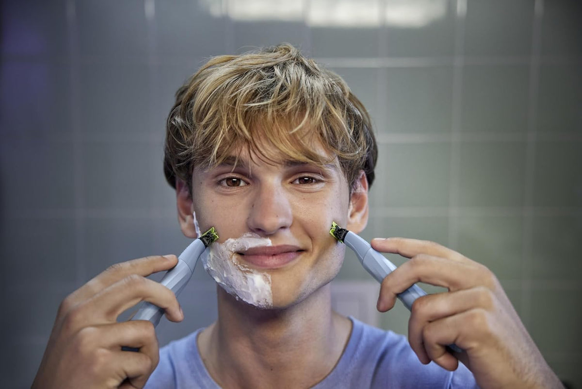 PHILIPS OneBlade being rinsed in shower showing waterproof cleaning benefit