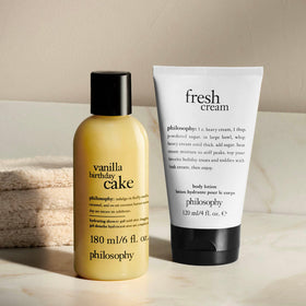philosophy lifestyle image in bathroom showing duo on shelf for travel and daily use