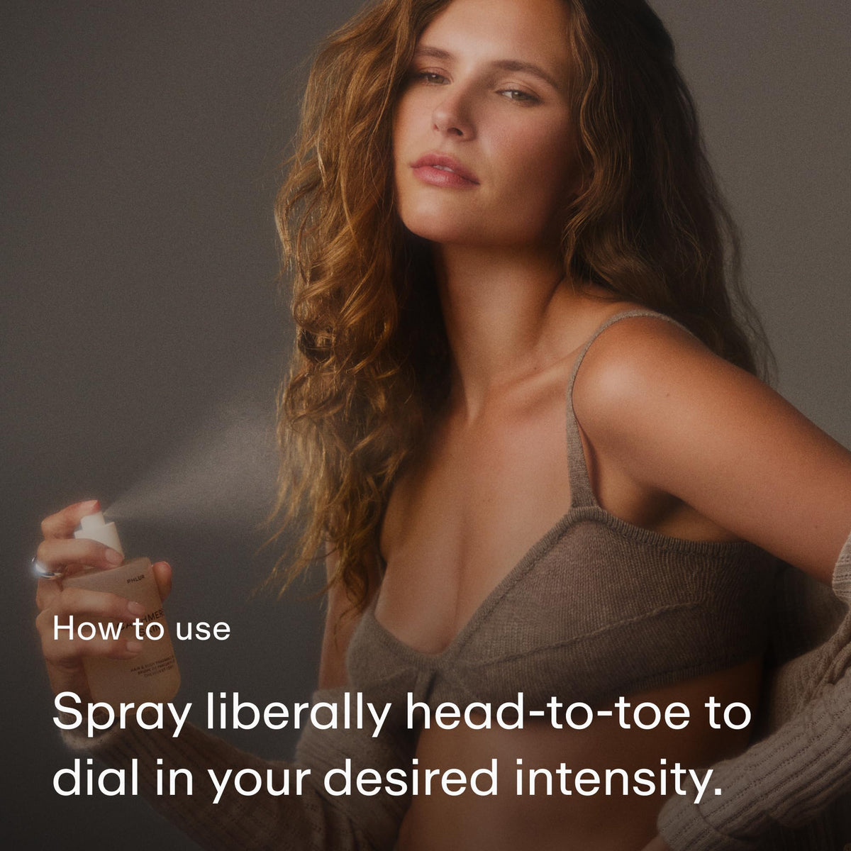 PHLUR hair mist in use on mid-length hair for subtle scenting