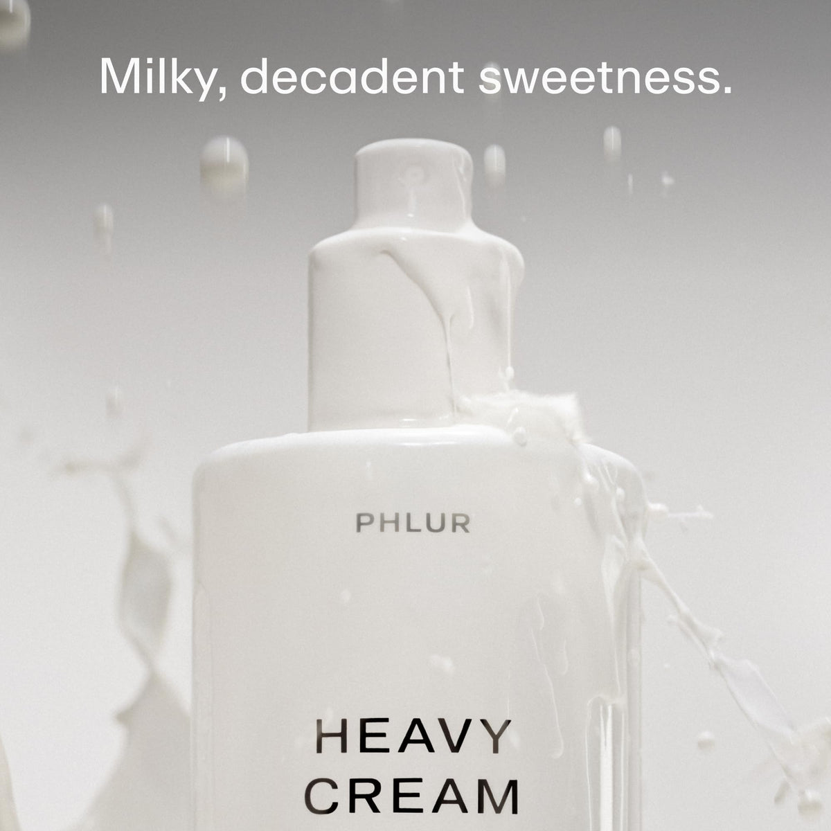 PHLUR Heavy Cream fine mist spray close-up demonstrating light application benefit