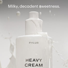 PHLUR Heavy Cream fine mist spray close-up demonstrating light application benefit