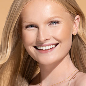 Physicians Formula wand applied on cheek to create defined contour