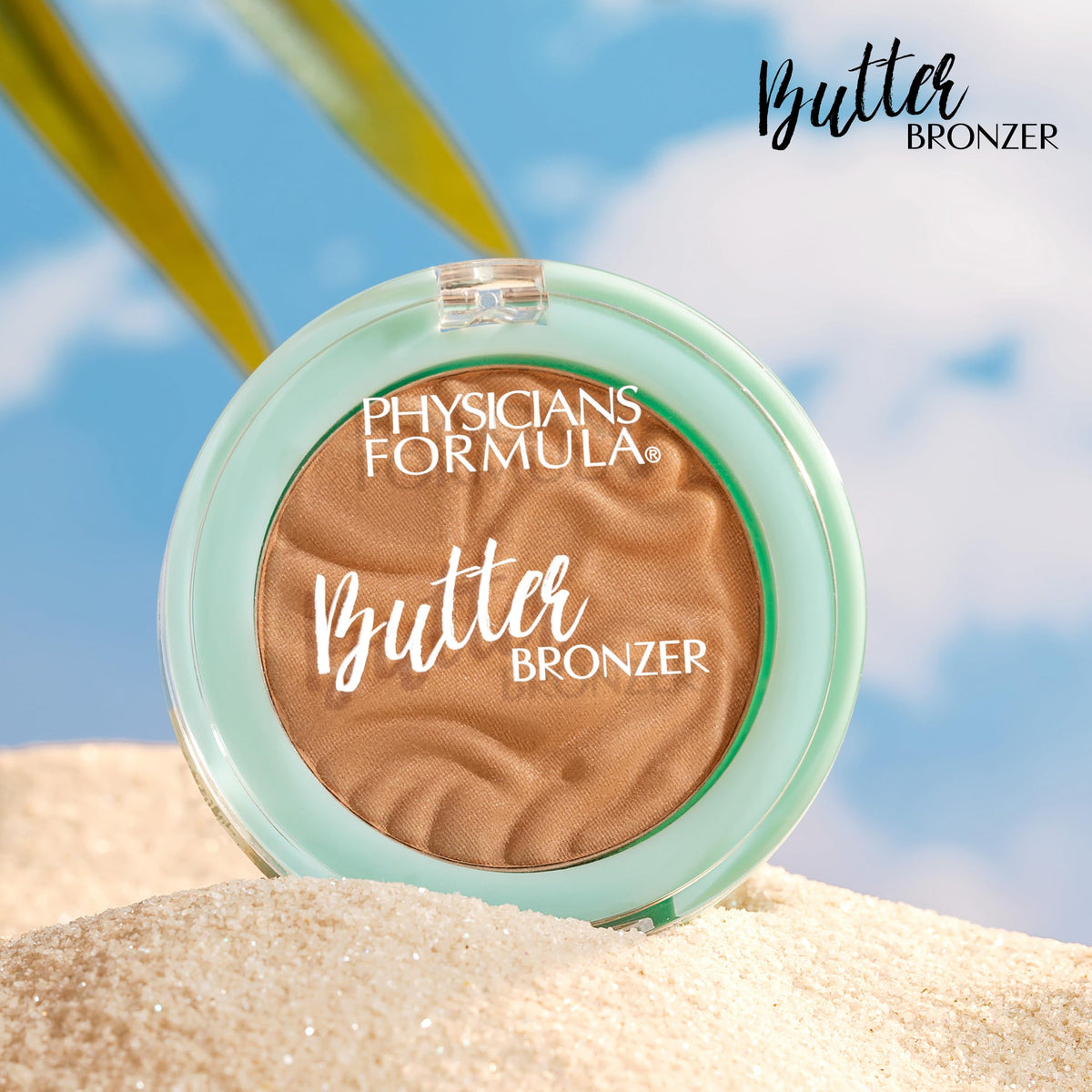 Physicians Formula mini bronzer next to a coin showing travel-friendly compact size