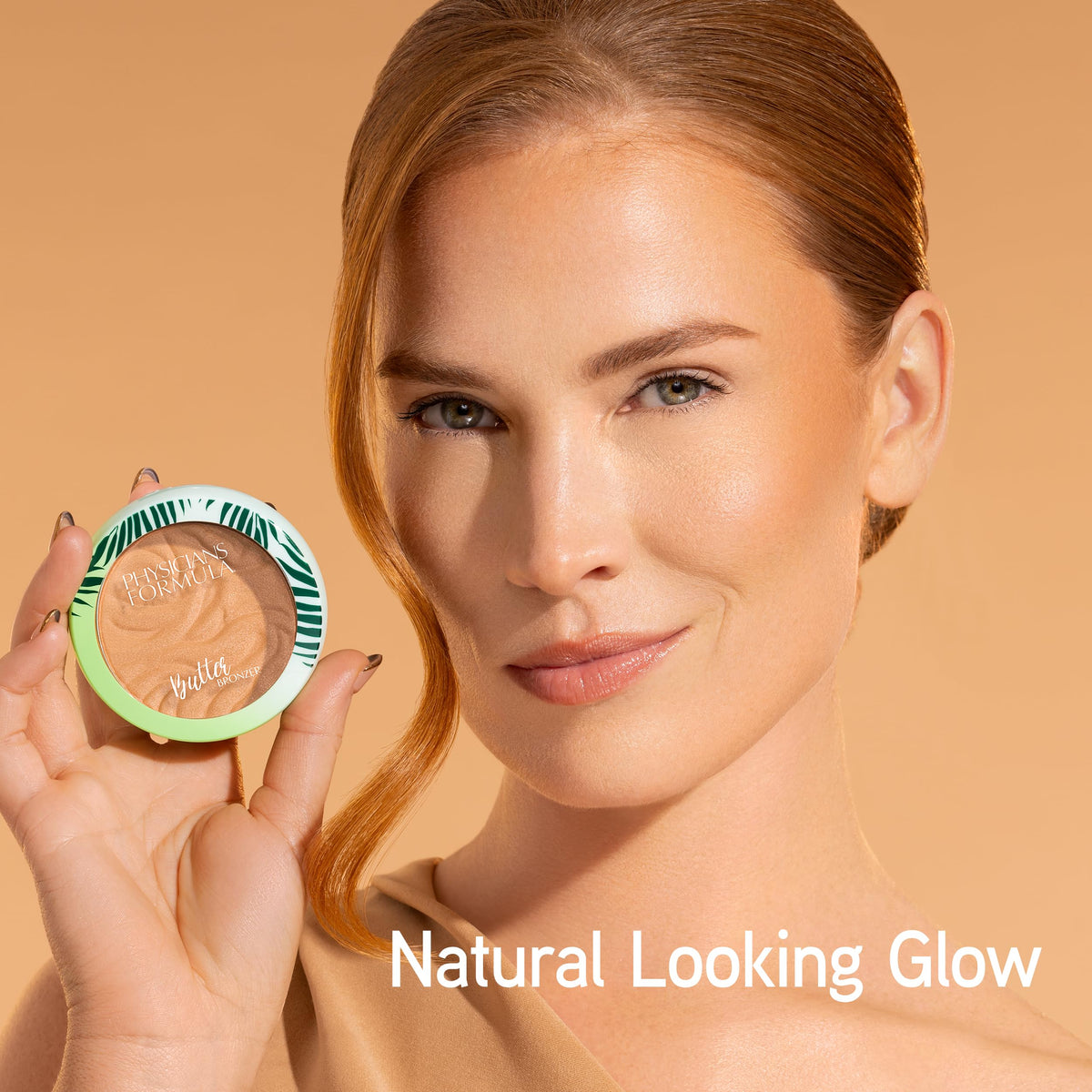 Physicians Formula bronzer held in hand to show size and travel-friendly benefit