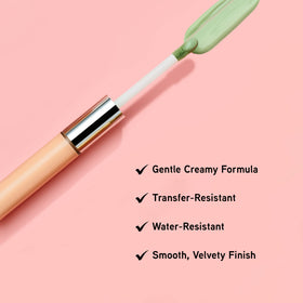 Physicians Formula concealer stick next to coin to show compact travel-friendly size