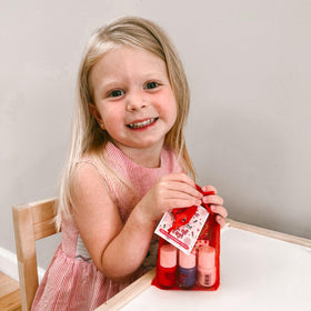 Family doing holiday nails at table using Piggy Paint set — safe bonding activity
