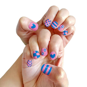 Child painting nails with Piggy Paint pens during a playdate showing simple application