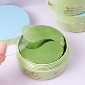Bowl with cucumber slices hyaluronic acid serum and caffeine ingredient visuals for Pixi benefits