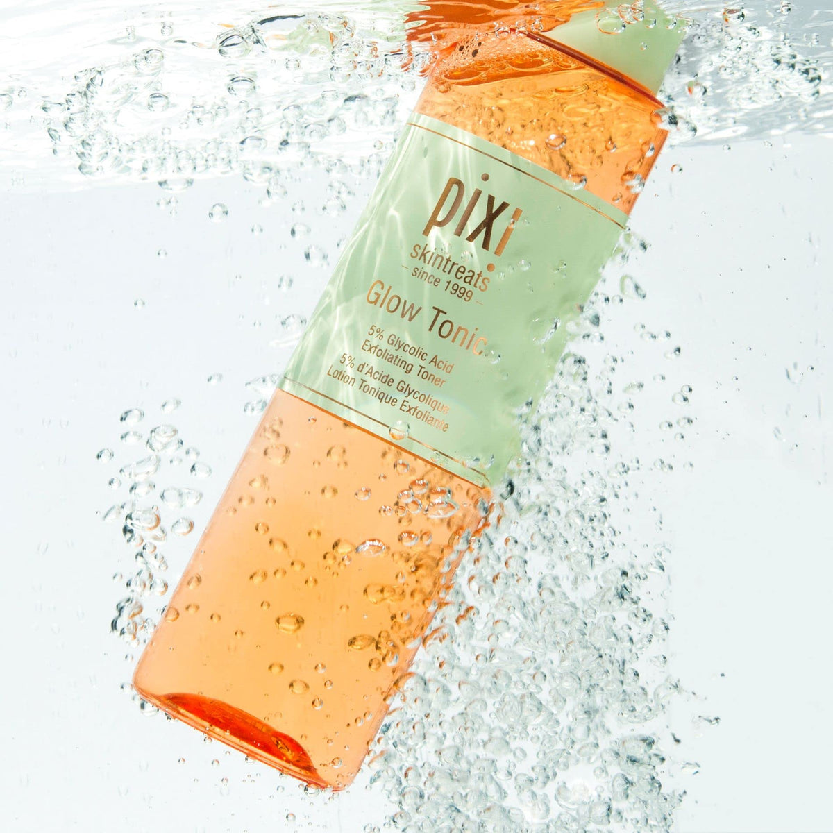 Ginseng and aloe leaves beside Pixi Glow Tonic bottle highlighting natural energizing and soothing benefits