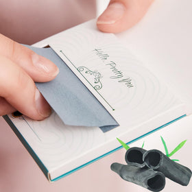 PleasingCare dispenser open with one sheet pulled out for sanitary single use