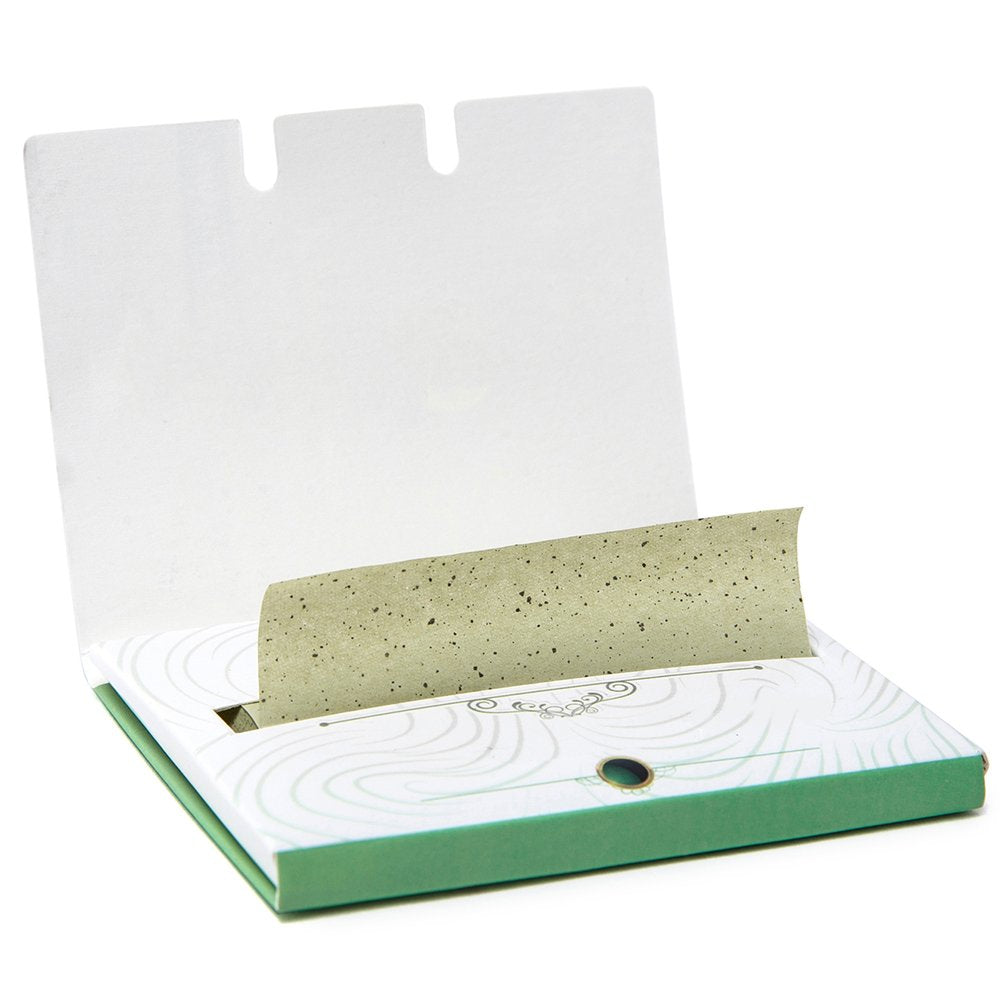 PleasingCare using sheet on face in mirror for discreet, makeup-safe touchup benefit