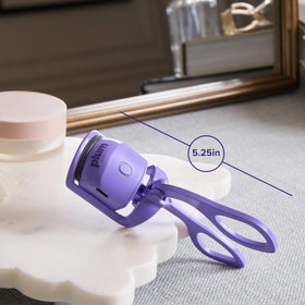 Plum Beauty curler beside USB-C cord highlighting fast recharge convenience benefit