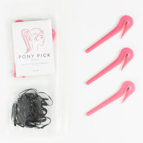Pony Pick placed on a bathroom vanity with styling tools, Pony Pick ready-for-use convenience