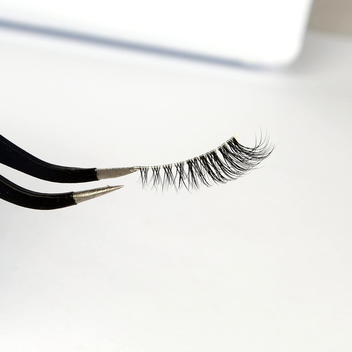 Pooplunch model wearing lashes to open and lift outer eye