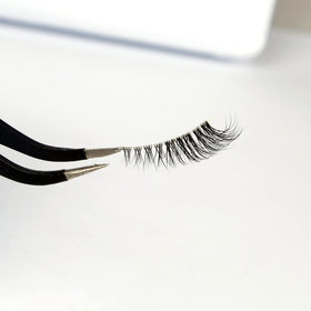 Pooplunch model wearing lashes to open and lift outer eye