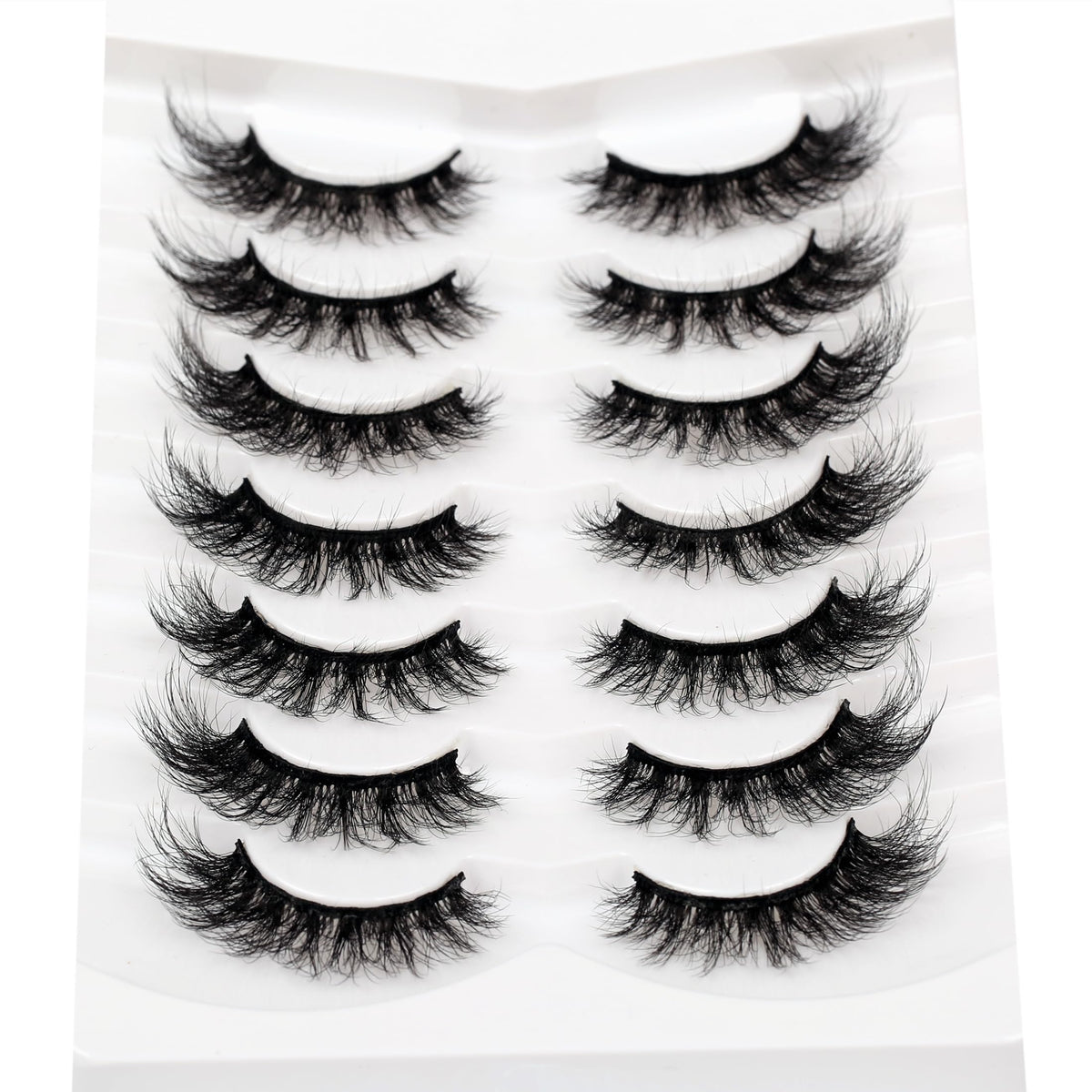 Pooplunch lashes beside ruler showing 16mm length for sizing clarity