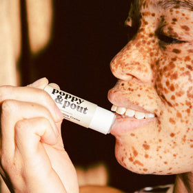 Poppy & Pout balm texture close-up demonstrating smooth glide and moisturizing effect