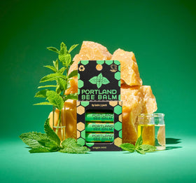 Portland Bee Balm organic coconut and olive oils displayed highlighting nourishing benefits