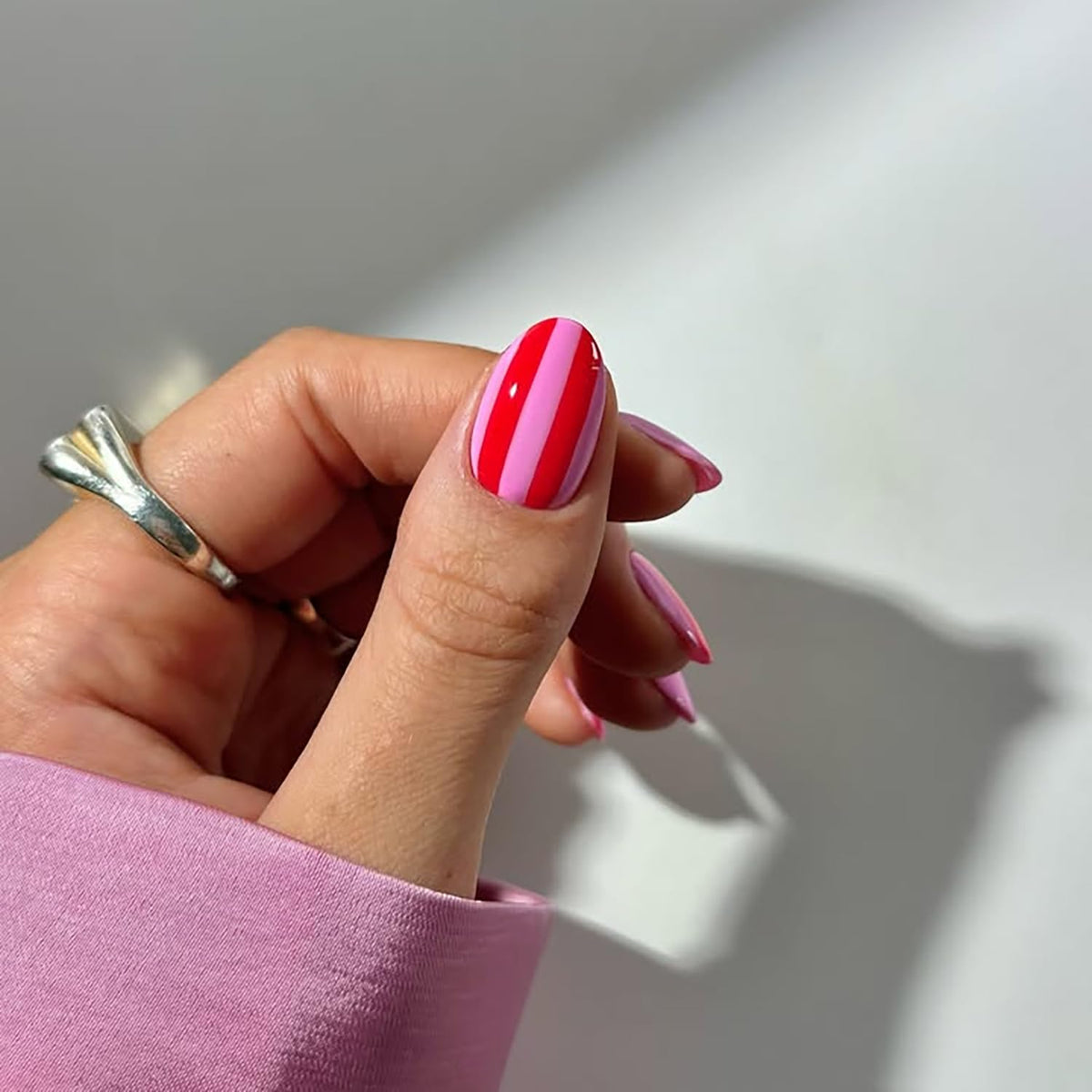 Posyofet being applied on a fingernail demonstrating fast at-home manicure