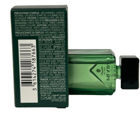 Prada Paradigme mini beside a credit card illustrating compact travel size
