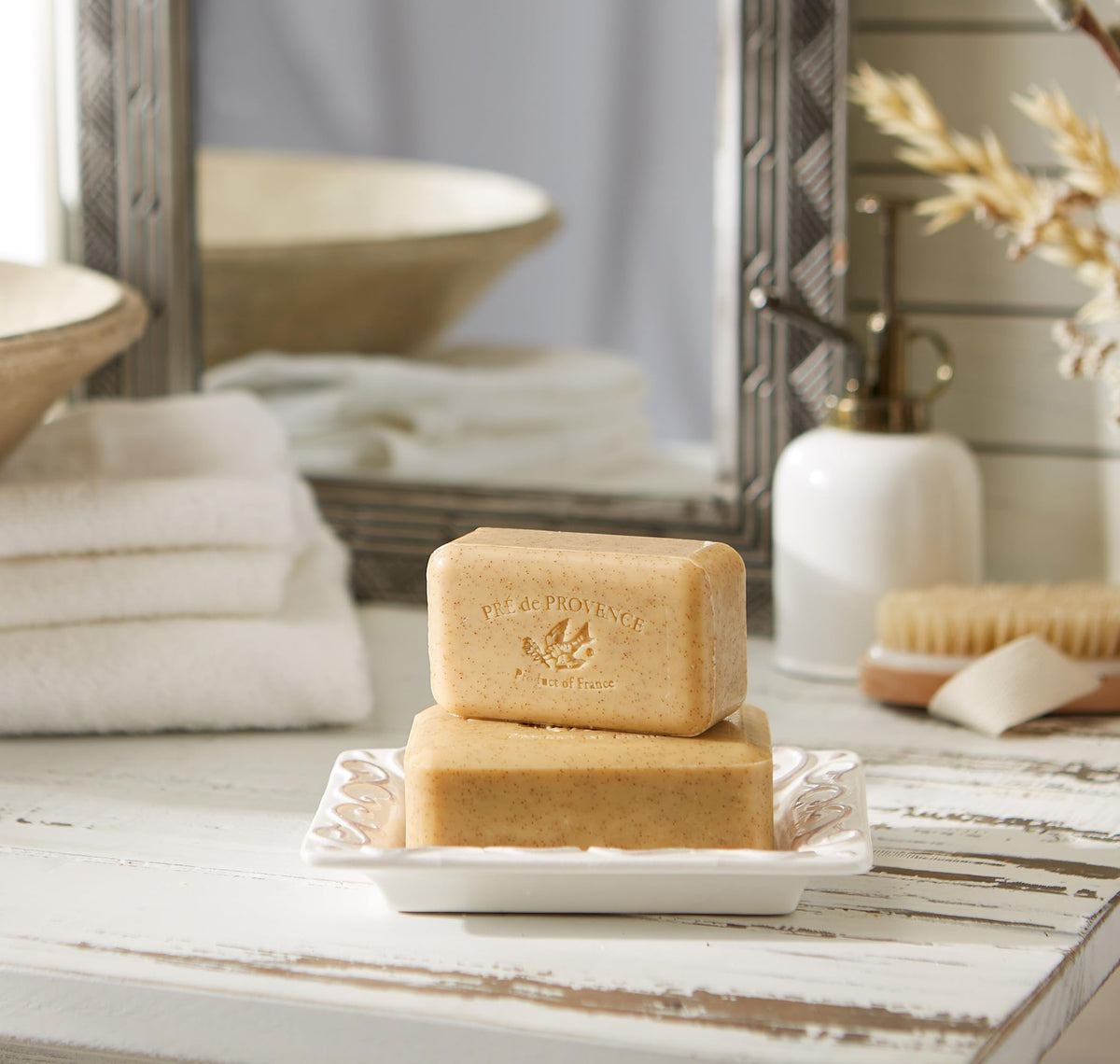 Pré de Provence bar resting on a draining dish to prolong soap life