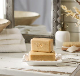 Pré de Provence bar resting on a draining dish to prolong soap life