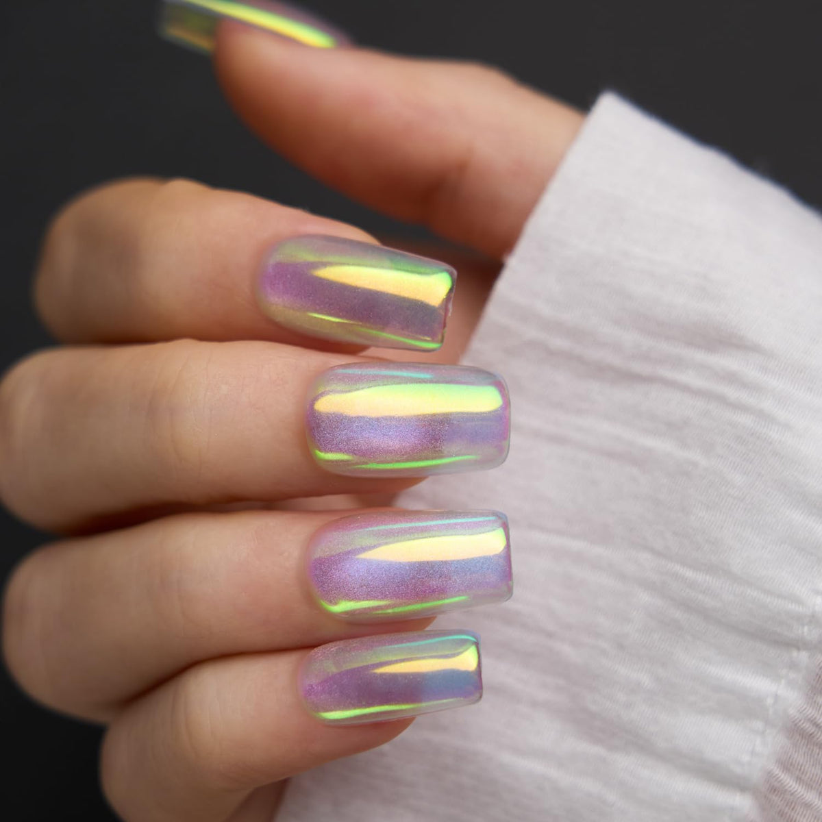 Pretty Diva finished manicure in lifestyle setting shows mermaid iridescence