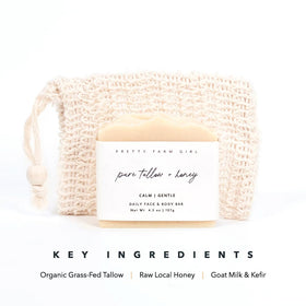 Pretty farm girl hand holding soap with lather demonstrating gentle cleanse