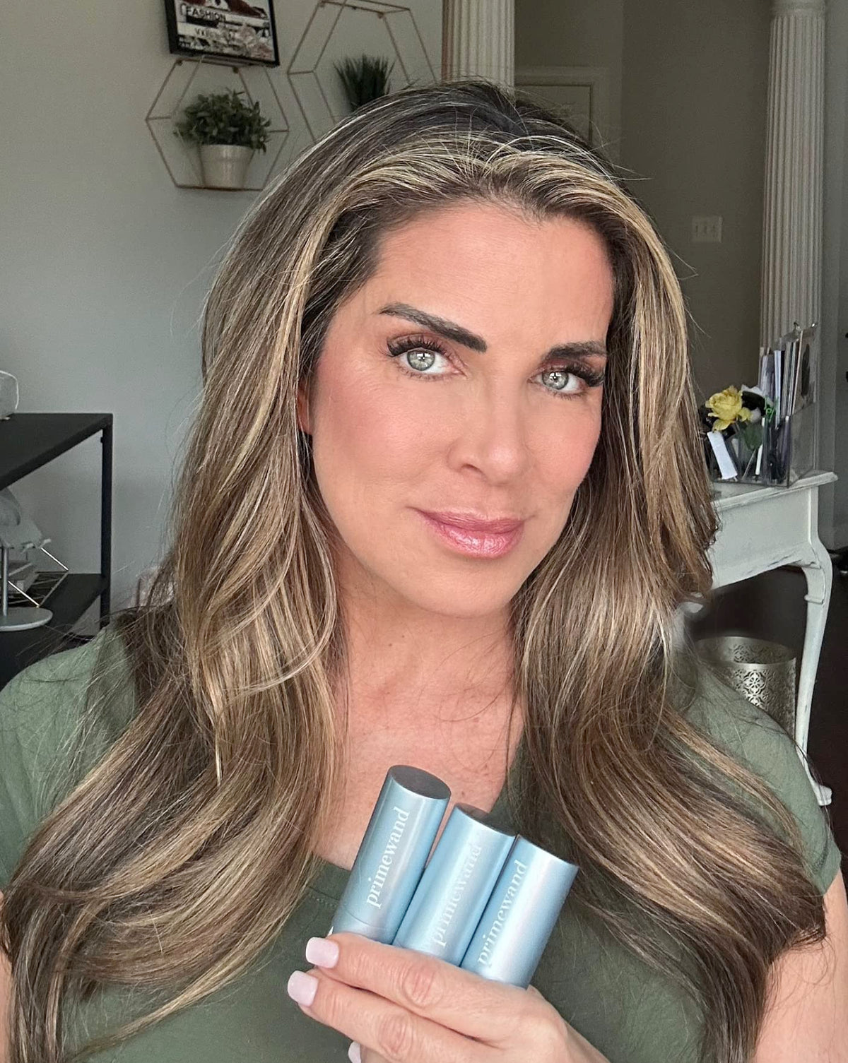 Prime Prometics PrimeWand Pearl on cheekbone in lifestyle shot adding youthful luminosity