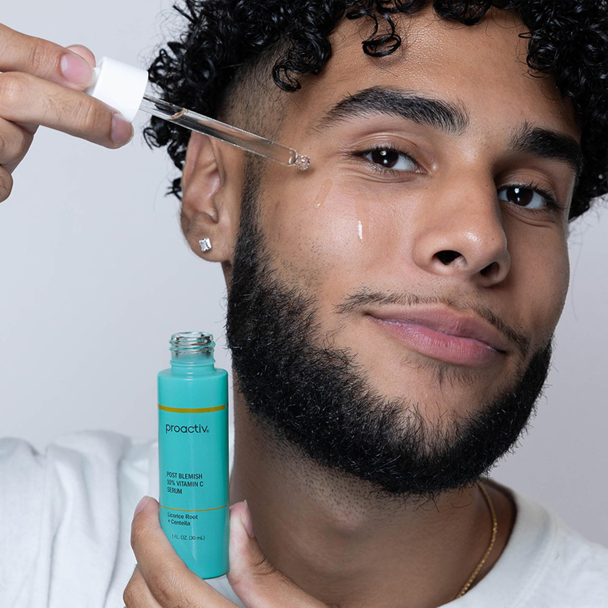 Proactiv serum bottle next to ruler showing compact travel-friendly size