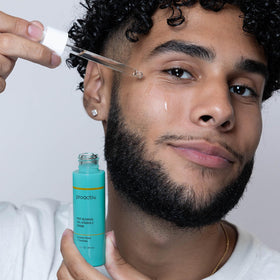 Proactiv serum bottle next to ruler showing compact travel-friendly size