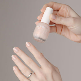 Manicured hands using Probelle polish for instant brighter-looking nails