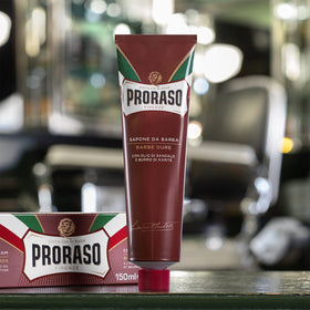 Proraso tube held in hand indicating compact 5.2oz travel-friendly size
