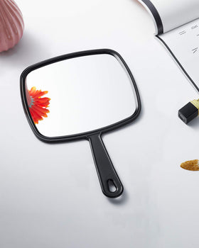 PROTECLE stylist using handheld mirror demonstrating client consultation benefit and accuracy