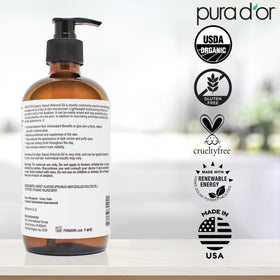 PURA D'OR bottle beside towels and diffuser in bathroom to suggest relaxing aromatherapy use