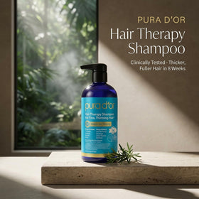 PURA D'OR shampoo texture poured with bubbles, demonstrates gentle sulfate-free cleanse