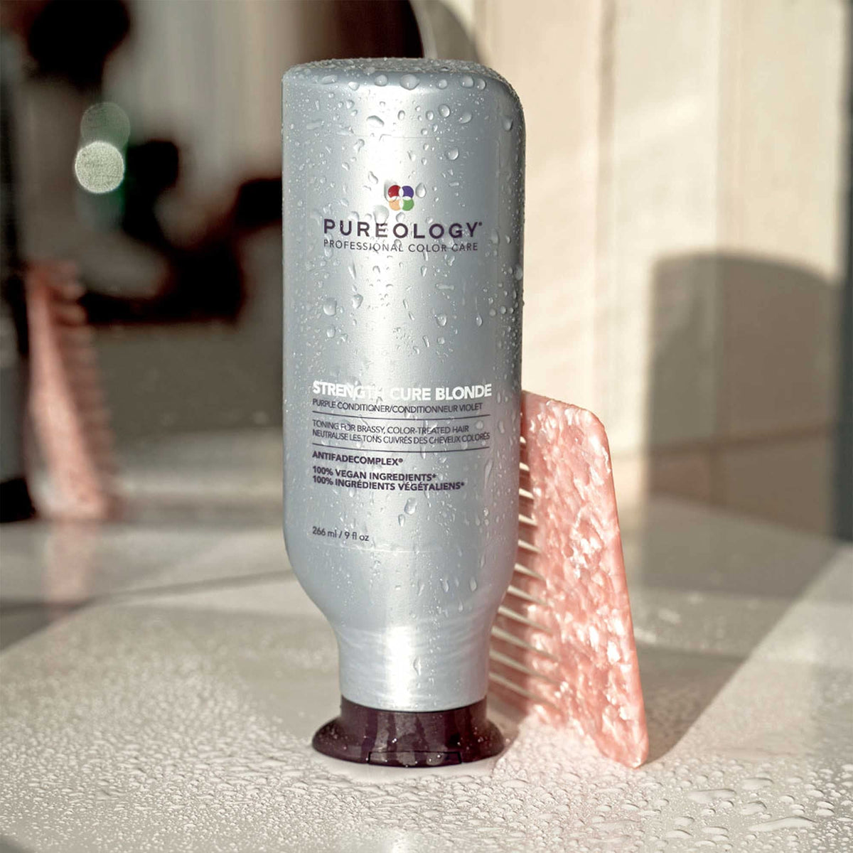 Pureology product paired with shampoo in lifestyle setting for boosted color care