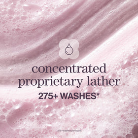 Hand applying Pureology shampoo at sink with brand visible for easy root cleansing