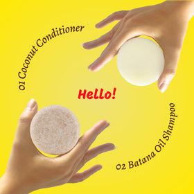 PureRootss bars held in hand for scale showing compact size and travel-friendly solid format