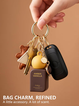 PUREU clip-on keychain attached to bag for hands-free portability and quick reapplication