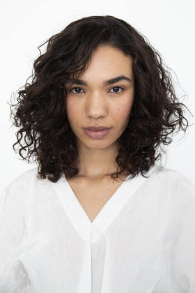 R+Co products on bathroom sink during wash day, curated routine and curl-enhancement benefit