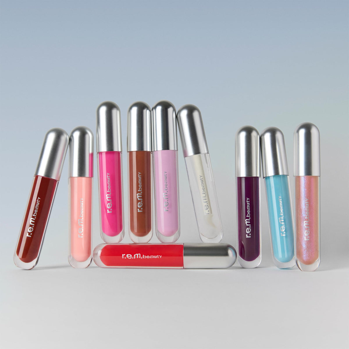 r.e.m. beauty lip swatch on model displaying sheer cotton candy tint and luminous shine