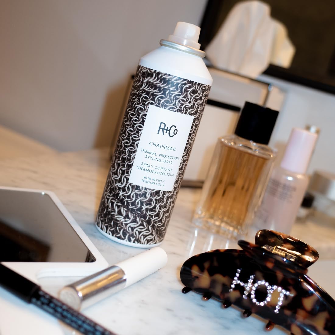 R+Co Chainmail being sprayed on damp hair to protect before blow-drying